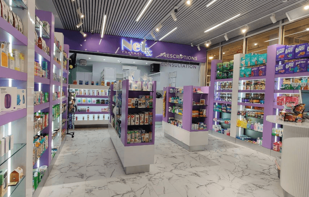 pharmacist greeting a patient inside NetRx Pharmacy